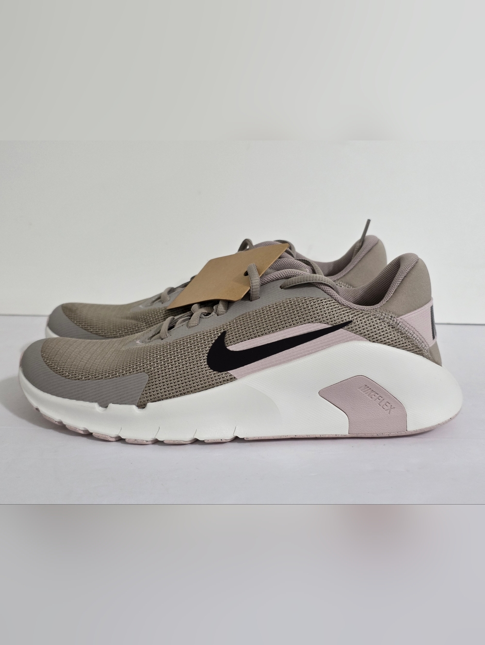 Nike taupe and blush low-profile running sneakers with black Swoosh